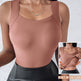 Brown tank top with built-in shelf bra worn by a person, on a textured white background.