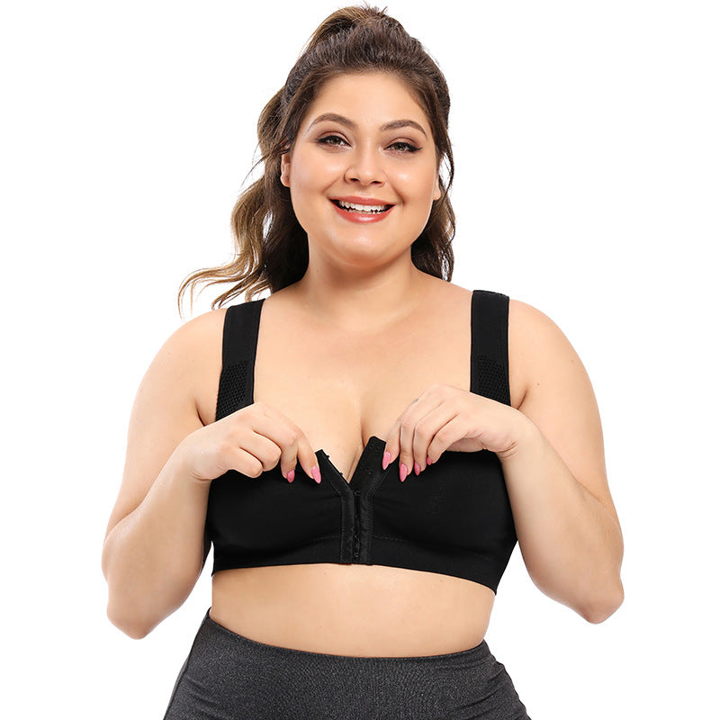 Woman wearing a black zip-up sports bra on a white background