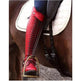 Red equestrian boot with stirrup on a horse