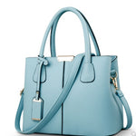 Light blue handbag with a strap on a white background
