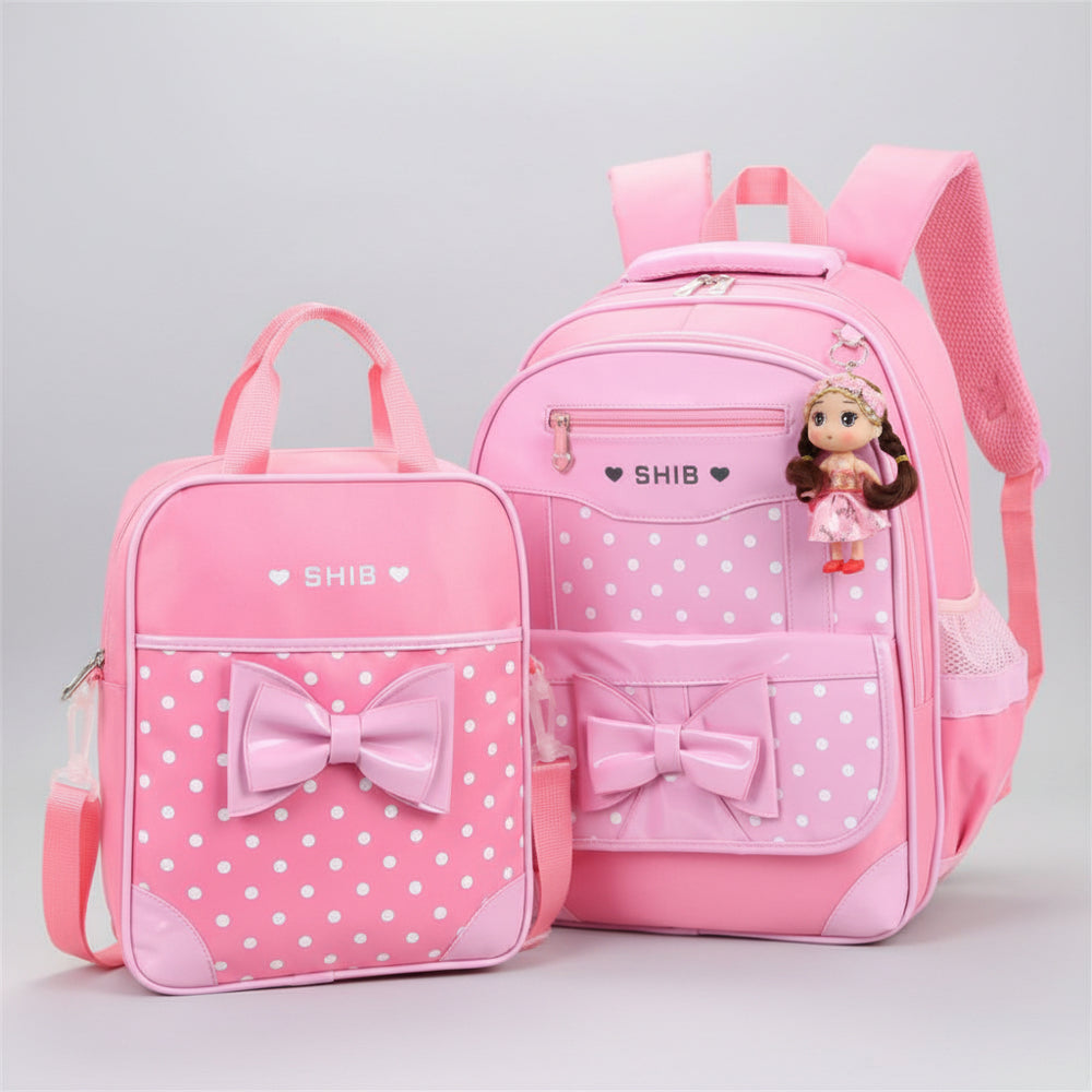 Pink polka dot backpack and lunch bag set with bow details on a white background
