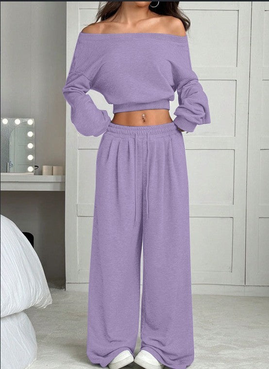 Person wearing a purple outfit in a bedroom setting