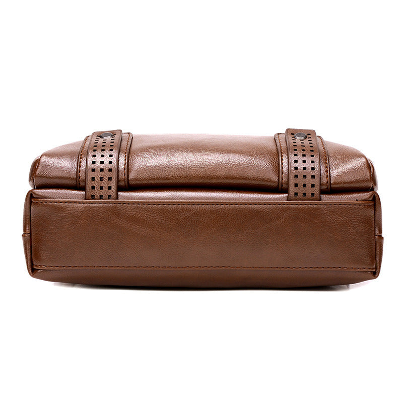 Brown leather clutch bag with decorative straps on a white background