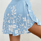 Light blue skirt with white floral pattern on a plain background