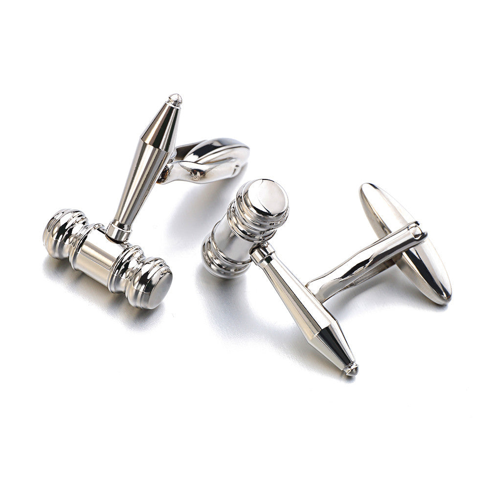 Silver gavel cufflinks on a white background