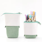 Green and white pencil case with stationery items on a white background