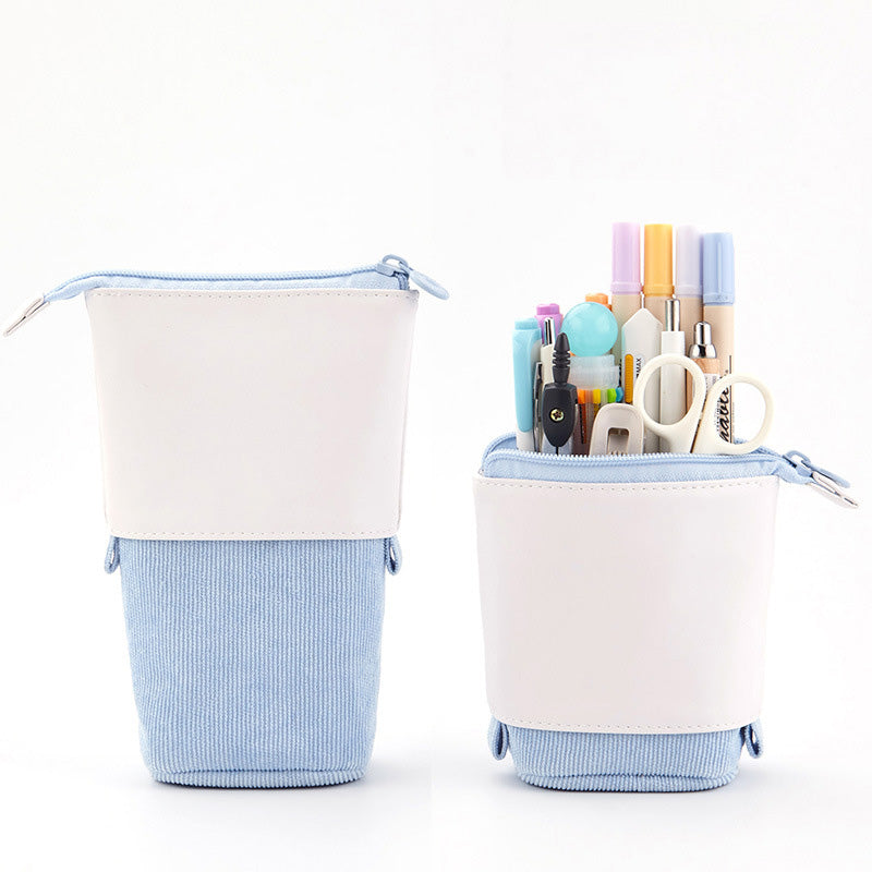 Two cylindrical pencil cases with stationery items on a white background
