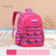 Pink and blue checkered backpack with 'Zmbaby' branding on a beige background