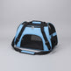 Blue pet carrier with black straps on a carpeted floor