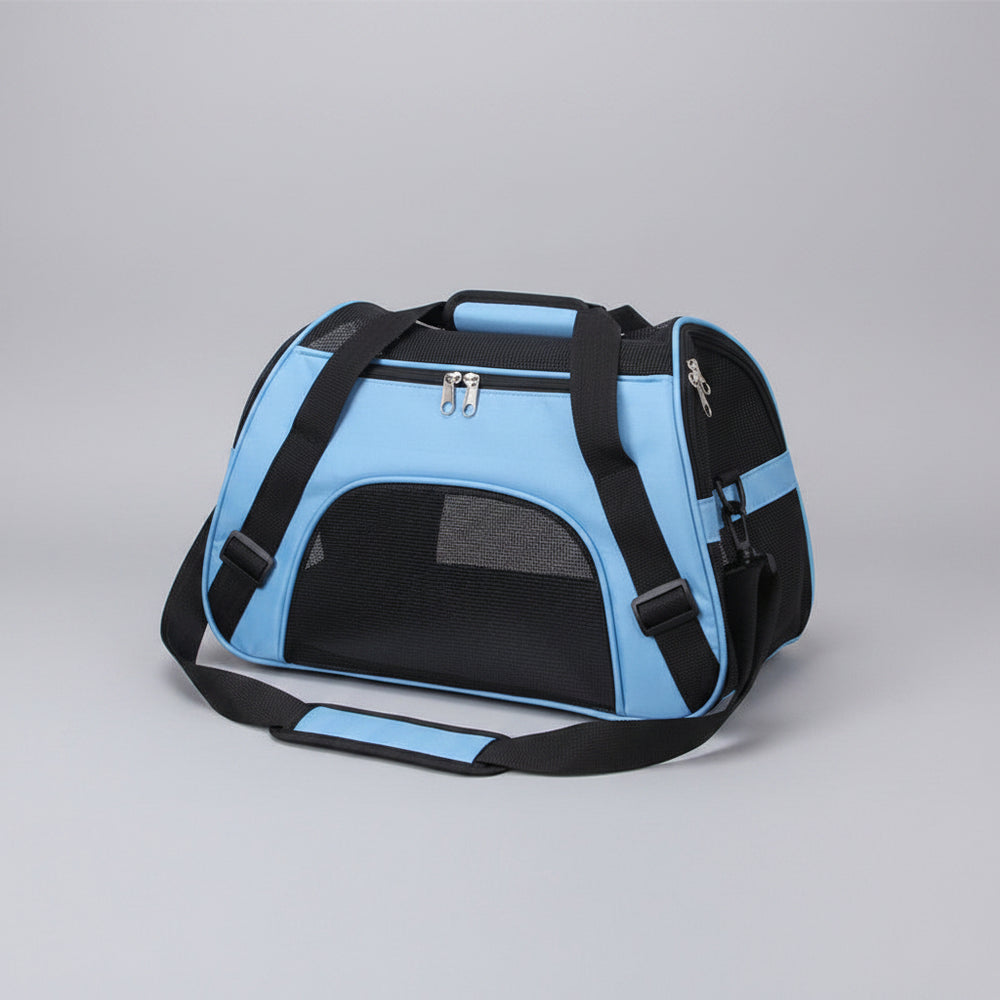 Blue pet carrier with black straps on a carpeted floor