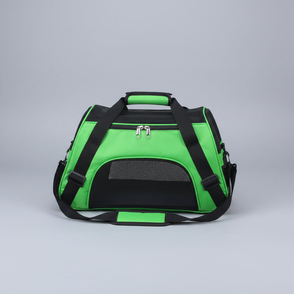 Green pet carrier with black straps on a carpeted floor