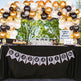 Graduation-themed table with balloons, decorations, and a 'Graduation' banner.