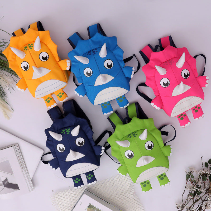 Five colorful dinosaur-shaped backpacks on a white surface.