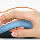 Hand holding a blue ergonomic mouse on a white background