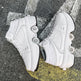 White roller skates on a textured surface