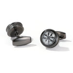 Black cufflinks with intricate design on a white background
