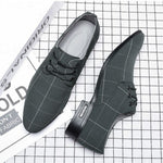 Pair of gray checkered shoes on a grid background