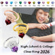 Graduation-themed class ring with heart-shaped gemstones and personalized names, displayed with a person in graduation attire.