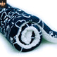Folded navy blue blanket with white paw print pattern on a white background