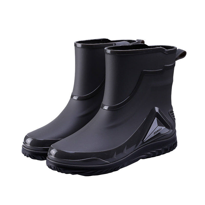 Pair of black rubber boots on a white background