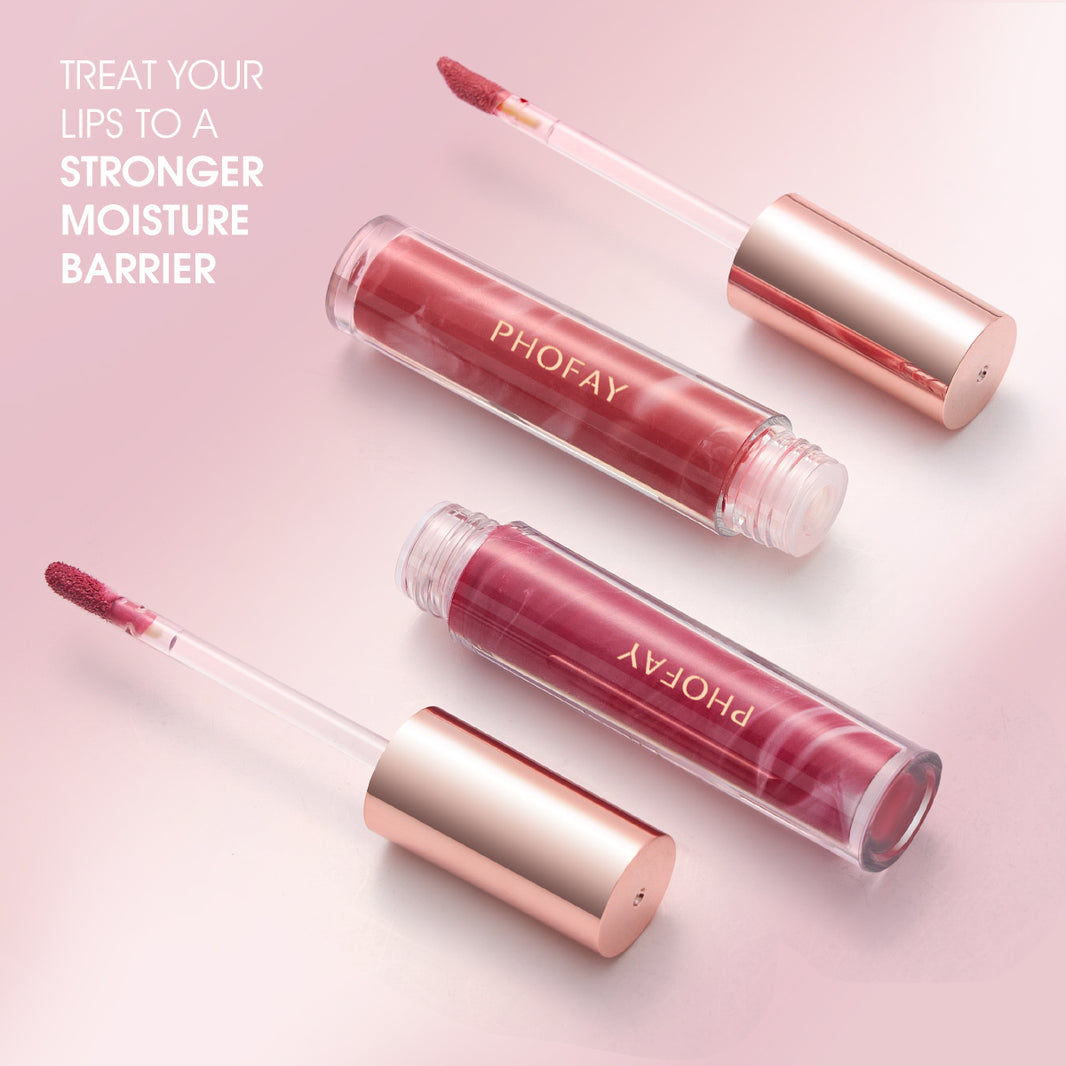 Three lip glosses with rose gold applicators on a pink background, featuring the brand 'PHOFAY'.