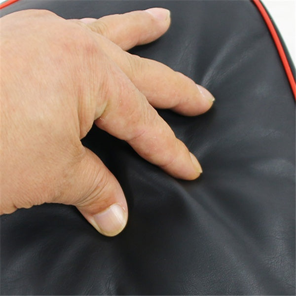 Hand touching a black surface with red edges
