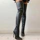Black leather knee-high boots on a light background