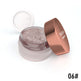 Open jar of glittery makeup with a rose gold lid on a white background