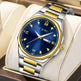 Luxury TOMI watch with blue dial and gold accents on a beige cushion