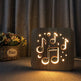 Wooden night light with musical note designs on a surface with a curtain background