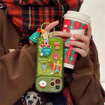 Caso protector de iPhone de silicona con temas de Navidad con chicas colgantes