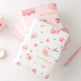Set of stationery items with floral design on a white background