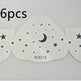Six star-shaped cutouts with moon and star patterns on a white background.