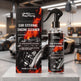 RayHong Car External Engine Cleaner shown as a clear spray bottle with a black trigger top next to its black retail box, both featuring fiery orange flame graphics and a car engine illustration, displayed on a light gray pedestal in a blurred garage setting.