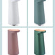 Four different colored soap dispensers arranged in a grid on a light blue background.