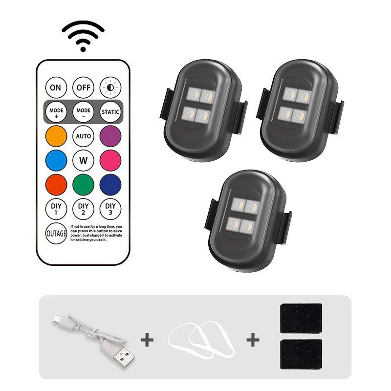 Set of three small lights with a remote control on a white background