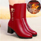 A pair of red faux-leather ankle boots with a chunky black block heel, featuring a decorative gold-tone crescent moon and flower charm on the outer side. The boots are shown on a model's foot, with a circular graphic overlay in the top right showing flames and the text 'Heat storage and warm winter series'.
