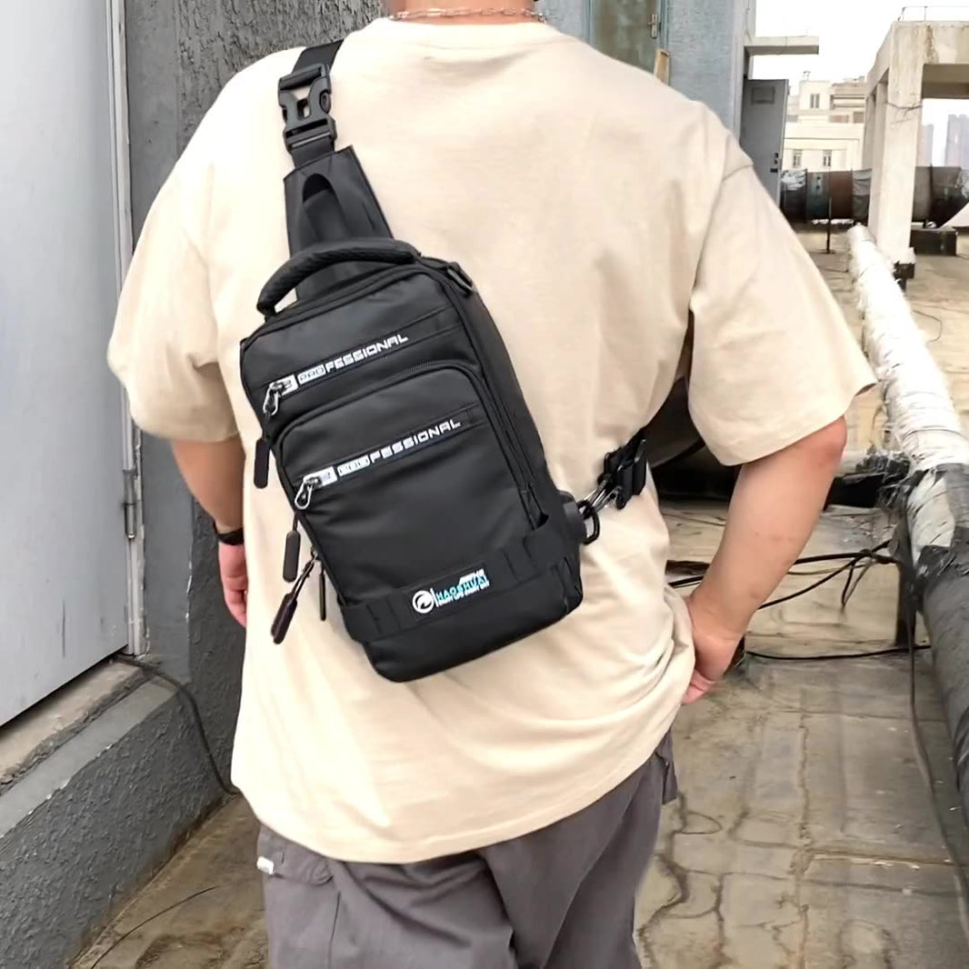 Person wearing a black sling bag with visible branding outdoors.