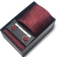 Maroon patterned tie set with tie clip and pocket square in a black box on a white background