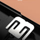 A stainless steel body scale with a large, stylized 'm' symbol on the platform, shown on a black surface against a split peach and black background with promotional text.