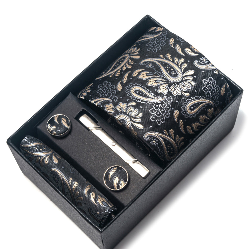 Set of cufflinks and tie clip in a decorative box with paisley pattern