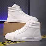 White high-top sneakers on a cardboard box with a dark background