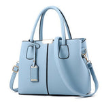 Light blue handbag with a shoulder strap on a white background