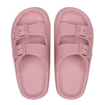 Pair of pink sandals with buckles on a white background