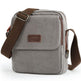 Gray shoulder bag with brown strap and visible brand logo on a white background