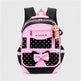 Pink and black backpack with a bow and polka dot pattern on a white background