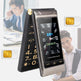 Flip phone with digital display and gold accents, shown open and closed, with people in the background.