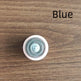 Round blue object with a white border on a wooden surface, labeled 'Blue'.