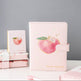 Pink planner with apple design on a gray background