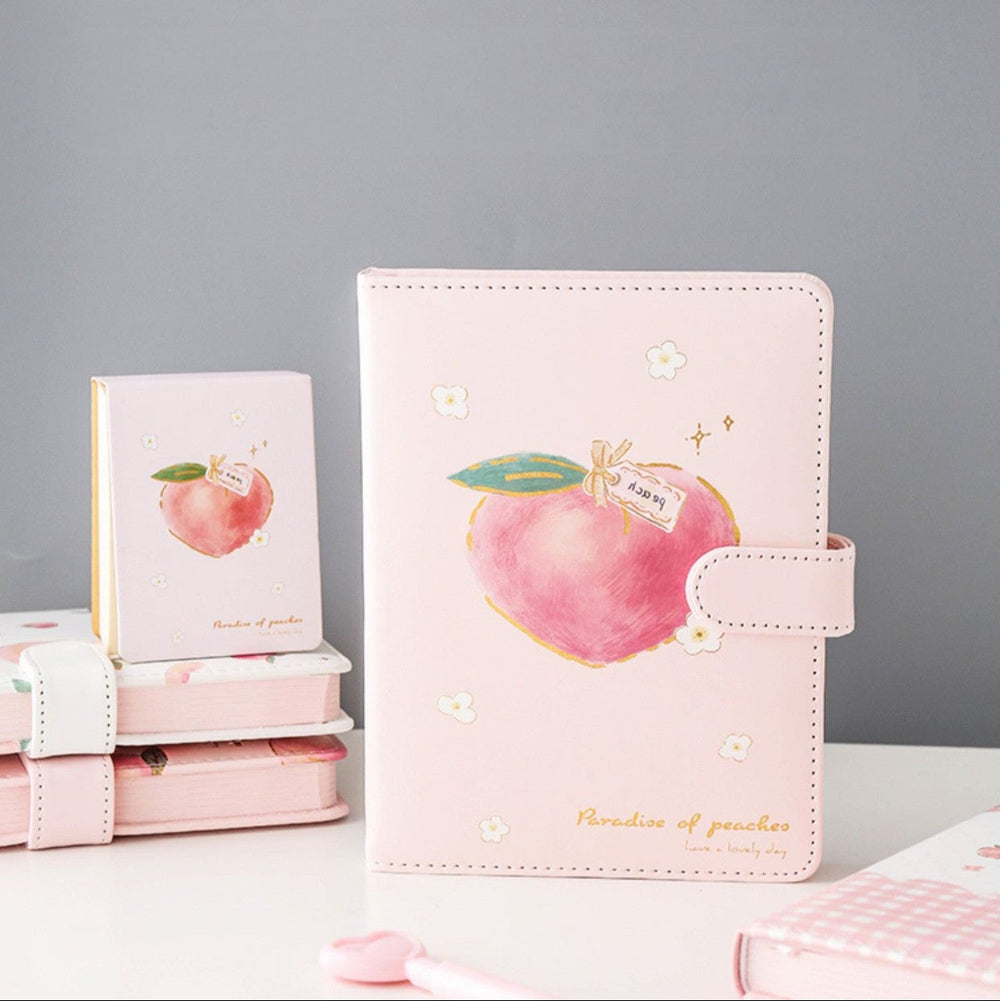 Pink planner with apple design on a gray background